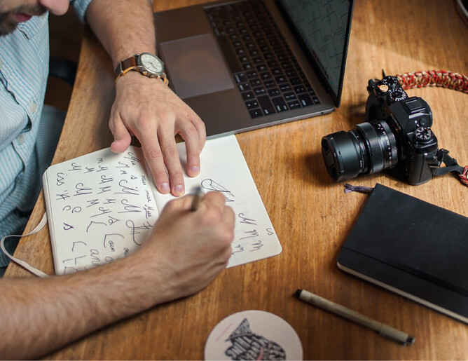 Photo of a designer drawing logo concepts