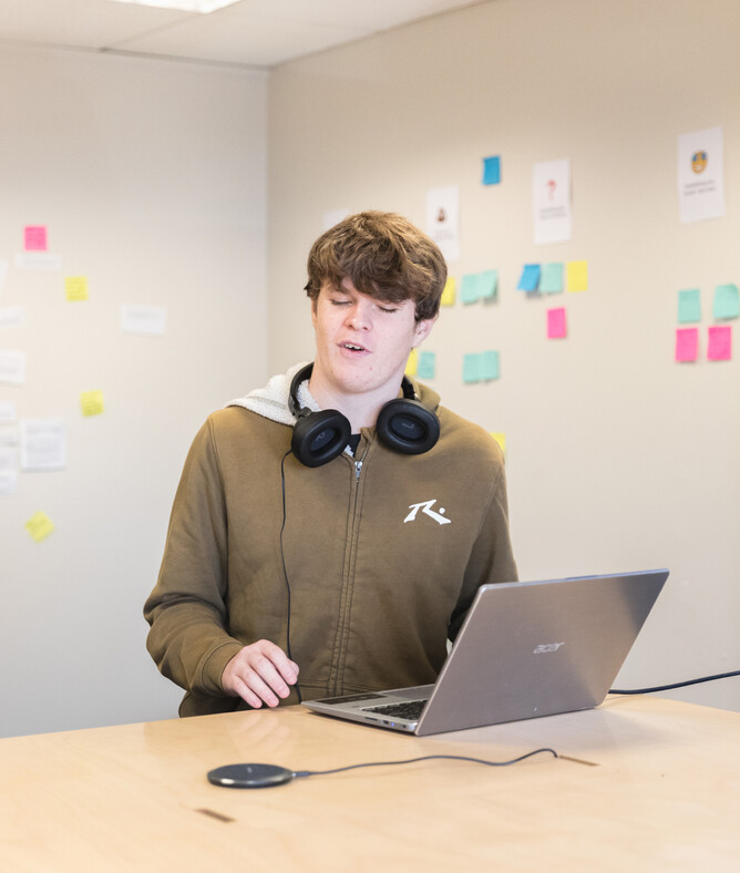 A close up of Lawson explaining his screenreader to the Rocketspark team