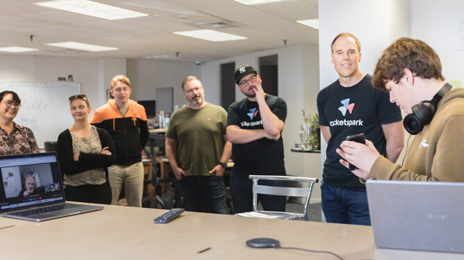 Lawson showing the Rocketspark team how he uses a screen reader on his phone